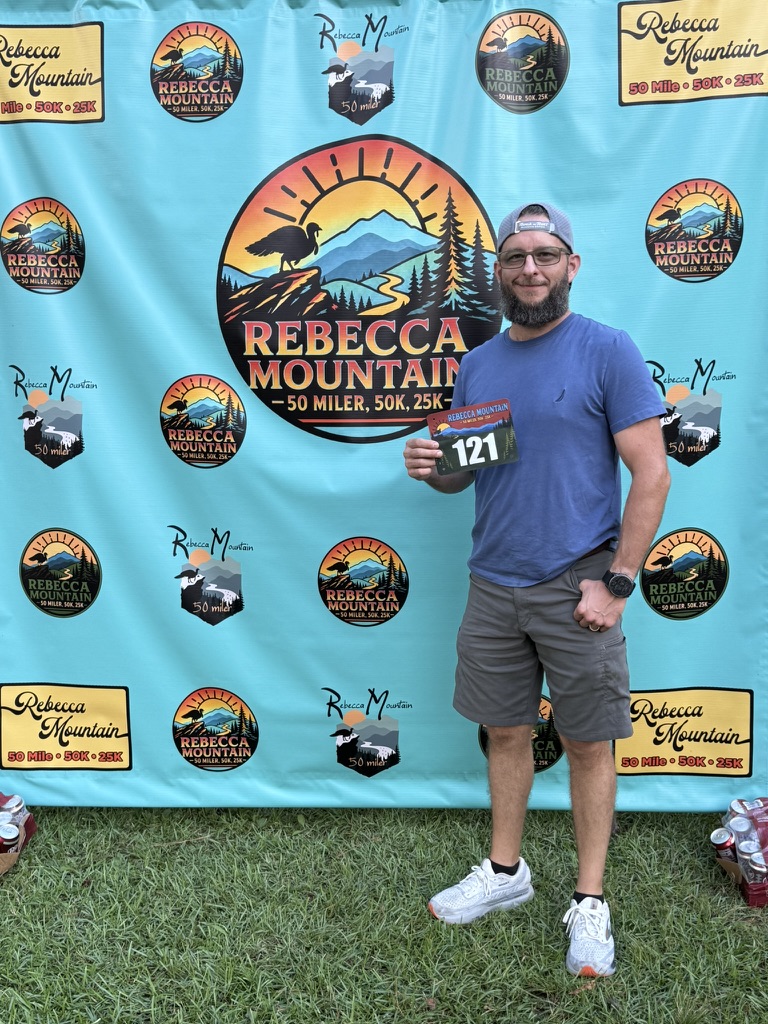 Nick holding race bib number 121 at Rebecca Mountain